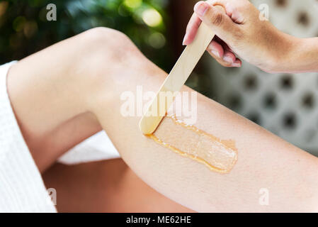 Woman getting legs waxed at a spa Stock Photo