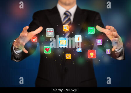 Elegant businessman holding colorful mixed media icons  Stock Photo