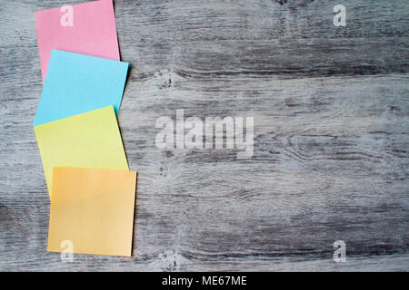 colored paper stickers on wooden table. blank office sticky notes. copy space. Stock Photo