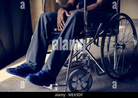 Disabled african man sitting on the wheelchair Stock Photo