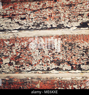 Dry brown paint on the wooden surface. Peeling. Cracked texture. Abandoned place decoration. Toned image. Scratched background. Toned. Old colorful wa Stock Photo