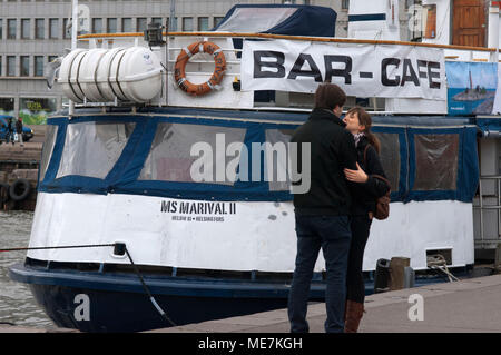 A couple kiss near the cruise terminal at Kauppatori, Helsinki, Finland. Stock Photo