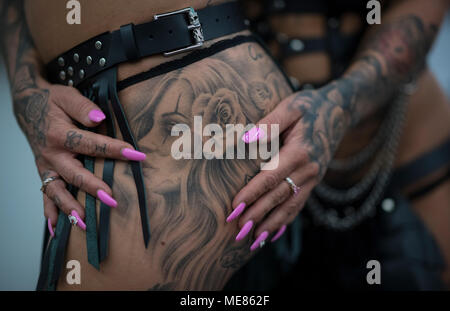 Frankfurt/Main, Germany. 21st April, 2018.  Women present their inked skin at a tattoo convention where tattoo artists and enthusiasts travel from far and wide to exchange ideas, techniques and knowledge. Credit: dpa picture alliance/Alamy Live News Stock Photo