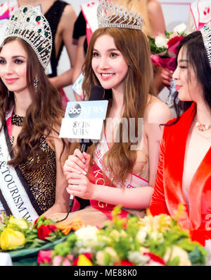 Salzburg, Austria. 21st Apr, 2018. Miss Hong Kong from China (C) speaks during the final of 2017-2018 World Miss of Culture & Tourism held in Salzburg, Austria, on April 20, 2018. Finalists from 21 countries and regions all over the world participated in the final of 2017-2018 World Miss of Culture & Tourism here on Friday. Credit: Pan Xu/Xinhua/Alamy Live News Stock Photo