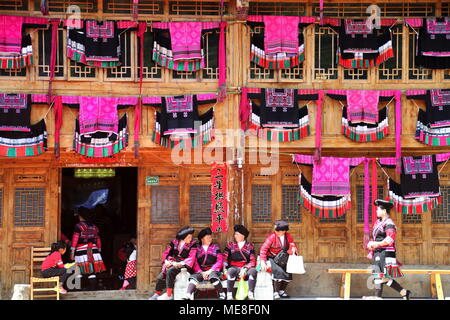 Beijing, China. 18th Apr, 2018. Photo taken on April 18, 2018 shows bright-colored embroidered clothes being hung on stilted buildings by women of Yao ethnic group during the celebration of 'San Yue San' festival at Huangluo Village in Longji Town of Longsheng, south China's Guangxi Zhuang Autonomous Region. Credit: Wang Zichuang/Xinhua/Alamy Live News Stock Photo