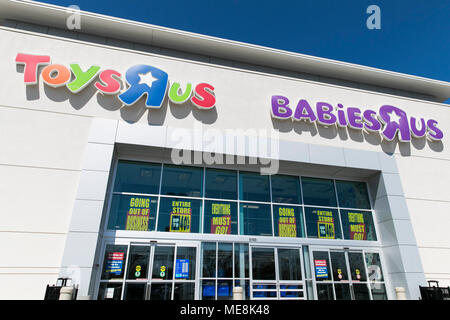 A logo sign outside of a joint Toys 'R' Us and Babies 'R' Us retail store in Columbia, Maryland with 'Going Out Of Business' signage on April 20, 2018 Stock Photo