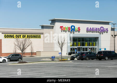 A logo sign outside of a joint Toys 'R' Us and Babies 'R' Us retail store in Columbia, Maryland with 'Going Out Of Business' signage on April 20, 2018 Stock Photo