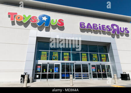 A logo sign outside of a joint Toys 'R' Us and Babies 'R' Us retail store in Columbia, Maryland with 'Going Out Of Business' signage on April 20, 2018 Stock Photo