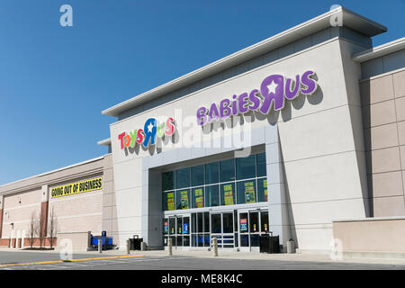 A logo sign outside of a joint Toys 'R' Us and Babies 'R' Us retail store in Columbia, Maryland with 'Going Out Of Business' signage on April 20, 2018 Stock Photo