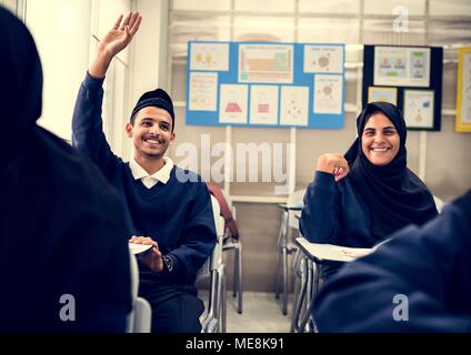 diverse muslim children studying in classroom Stock Photo