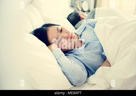 Couple on bed having an arguement Stock Photo