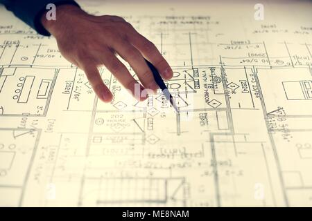 Close up of hands working on layout Stock Photo