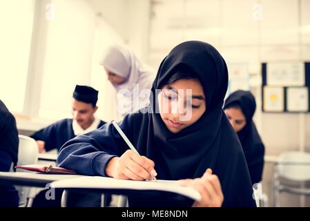 diverse muslim children studying in classroom Stock Photo