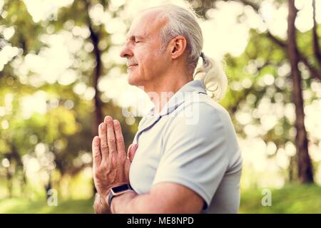 Person doing yoga at the park Stock Photo