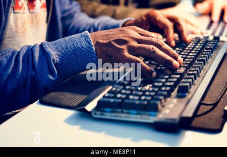 Closeup of hands working on computer keyboard Stock Photo