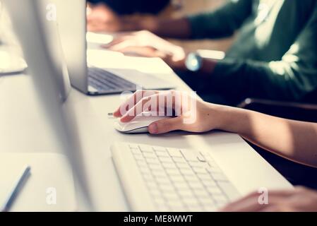 Close up of people's hand working on computer Stock Photo