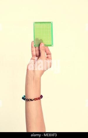Hand holding computer processor isolated on white background Stock Photo