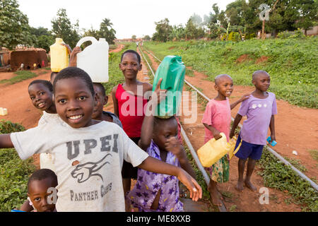Lugazi, Uganda. 17 May 2017. Smiling Ugandan children running on a railway track in a rural area in Uganda. Stock Photo