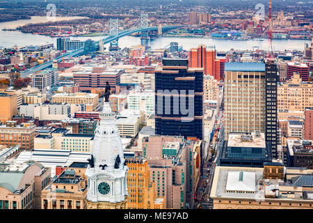 Aerial Philadelphia cityscape with the City Hall tower in the foreground and Ben Franklin bridge spanning Delaware river in the back Stock Photo