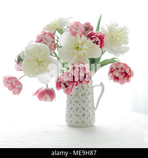 Tulips and Peonies in a pitcher Stock Photo