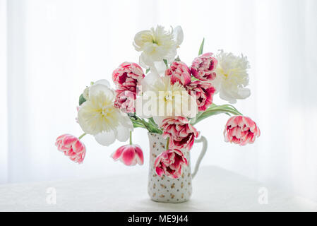 Tulips and Peonies in a pitcher Stock Photo