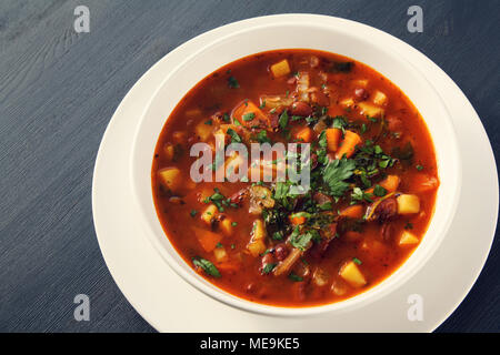 Tomato soup with red beans, potato and carrot. Vegan diet. European cuisine. Vegetarian dish. Main course. Organic meal. Stock Photo
