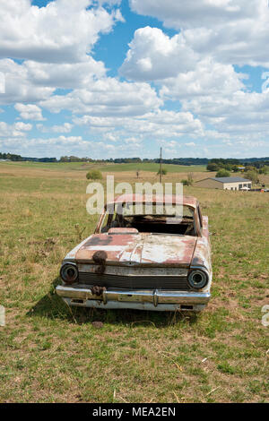 Wreck of Australian Holden car in farm field. New South Wales, Australia