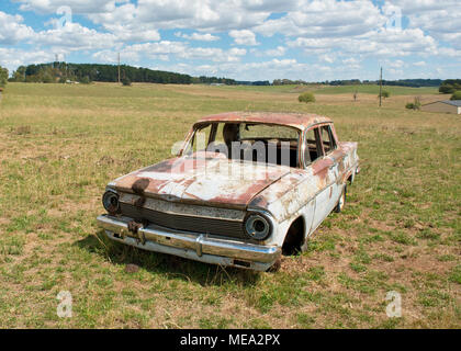 Wreck of Australian Holden car in farm field. New South Wales, Australia
