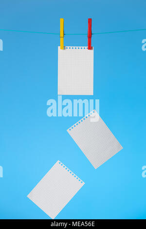 Concept of completed business notes. Notebook pages falling on blue background. Stock Photo