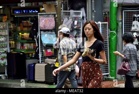 Chinese young woman in a busy, urban centre; Hong Kong, China Stock ...