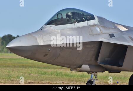 An Air Force pilot in the cockpit of a taxiing F-22 Raptor on the runway at Columbus Air Force Base. Stock Photo