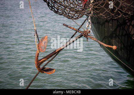 close up of a rusty anchor on the bow of a large barge Stock Photo