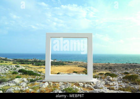 Stone sculpture look like a frame on the background of the sea in Cyprus, Ayia Napa. Sea view through the frame. Stock Photo