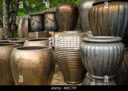 Large metallic brown coloured ceramic flower pots stacked at a plant nursery Stock Photo