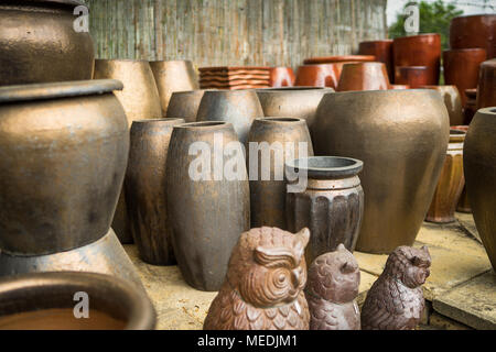 Large metallic brown coloured ceramic flower pots stacked at a plant nursery Stock Photo