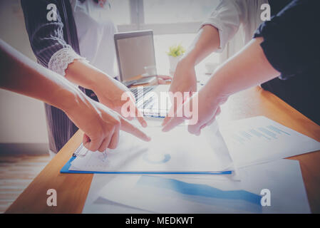 Business meeting, man's hands pointing on charts. Reflection light and flare. Concept image of data gathering and statistical working. Stock Photo