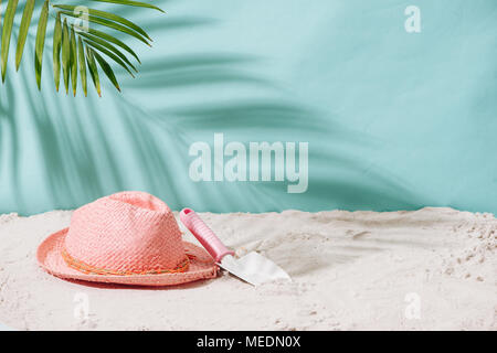 Sandy beach with towel, hat and summer accessories with copy space. Vacation and travel items. Tropical Holiday Background. Stock Photo