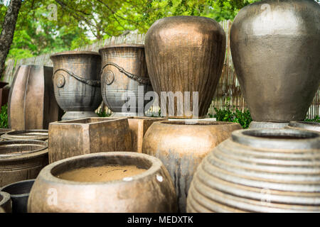 Large metallic brown coloured ceramic flower pots stacked at a plant nursery Stock Photo