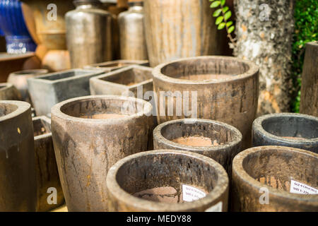 Large metallic brown coloured ceramic flower pots stacked at a plant nursery Stock Photo