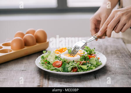 Lambs lettuce salad, hard-boiled eggs, tomatoes and honey mustard dressing Stock Photo