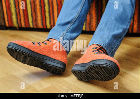 Orange felt shoes on the feet of a man. Stock Photo