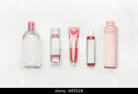 Pink natural cosmetic products : gel, lotion, serum, micellar water and toner,   bottles and tubes with branding mock up on white desk background , to Stock Photo