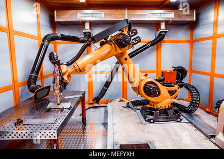 Fibre laser robotic remote cutting system. CNC Laser plasma cutting of metal, modern industrial technology. Stock Photo