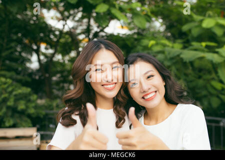 Happy friends or teenage girls having fun outdoors Stock Photo