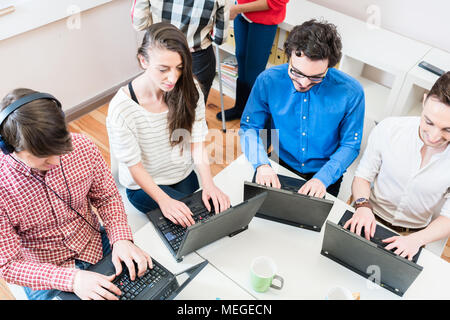 Programmer in startup business working on computer Stock Photo