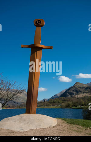 A 20 foot high iron sculpture of King Arthurs Excalibur stands beside Llyn Padarn in the village of Llanberis, North Wales. Stock Photo