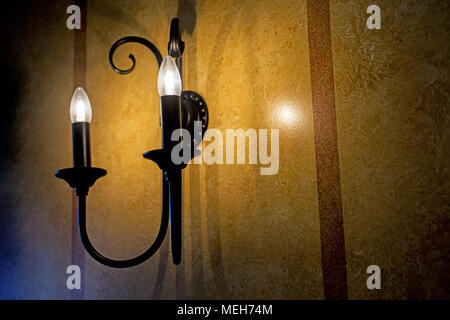 Decorative electric pendant on the wall. Abstract photo. Stock Photo
