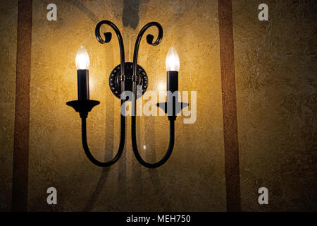Decorative electric pendant on the wall. Abstract photo. Stock Photo