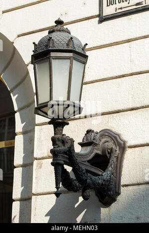 Decorative street lamp mounted on the facade of the building Stock Photo