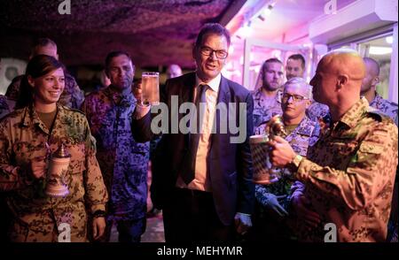 22 April 2018, Iraq, Erbil: Development Minister Gerd Mueller of the Christian Social Union (CSU) raises his glas together with German soldiers of the Bundeswehr during a visit of the German operation contingent and the multinational 'Kurdistan Training Coordination Centers'. Mueller is giving political talks in Iraq and is visiting aid organizations. Photo: Kay Nietfeld/dpa Stock Photo